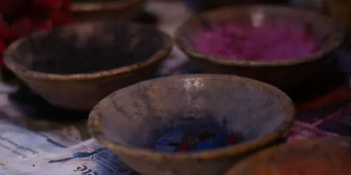 Bowls of natural dye pigments prepared for coloring wool in Moroccan rug making