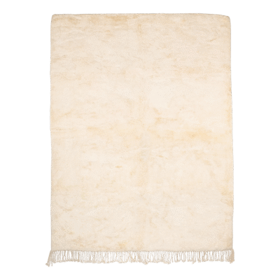 Minimalist rug in natural cream wool with fringed edges, handwoven in Morocco for a clean and timeless design.