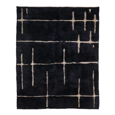 Black Moroccan rugs with bold white geometric patterns handwoven from natural wool by artisans.